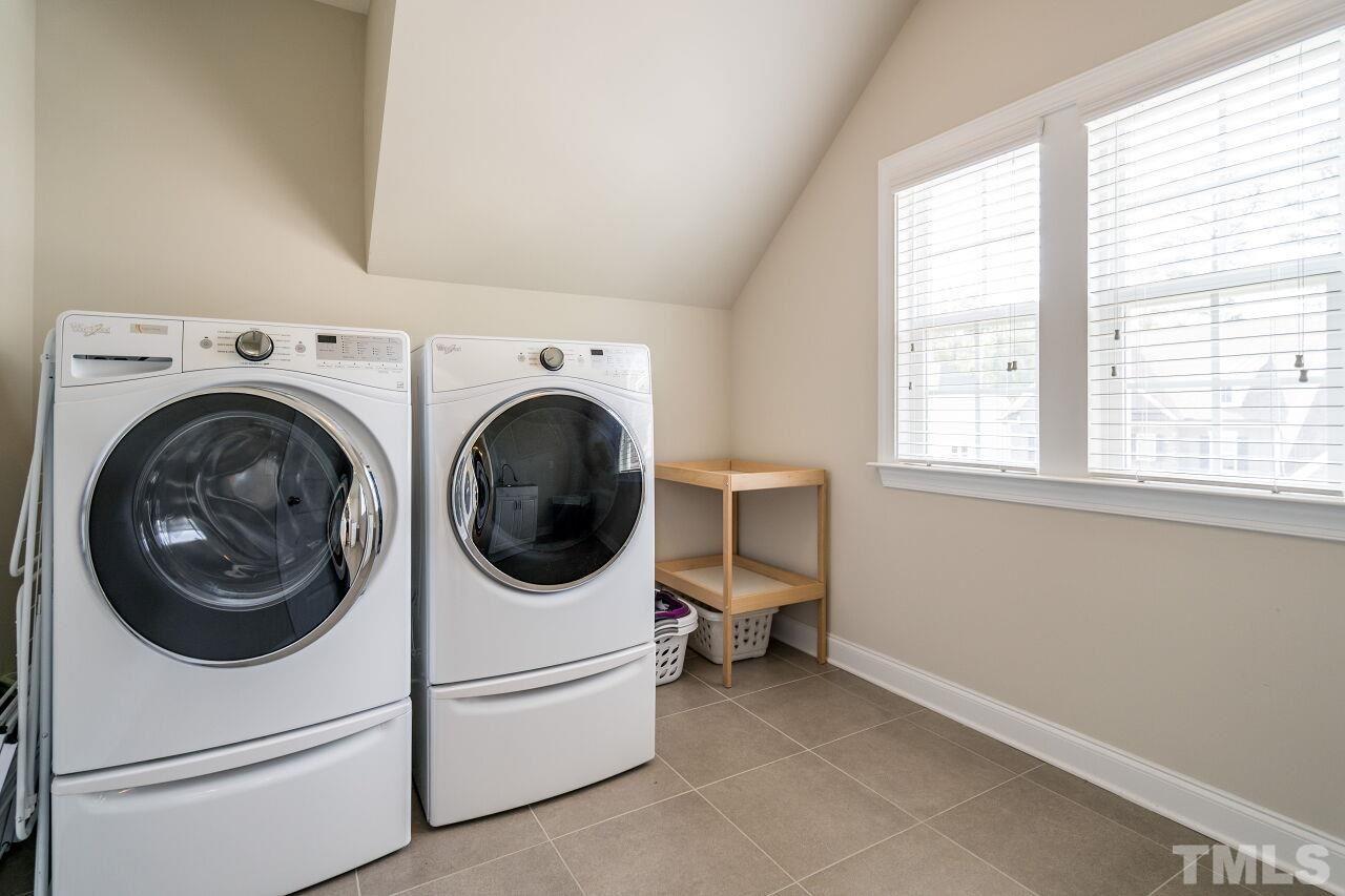 5264 Aleppo Lane Raleigh, NC 27613 - Photo 22 of 30 Huge, tiled, laundry room with sink and access to hall and owner's suite.
