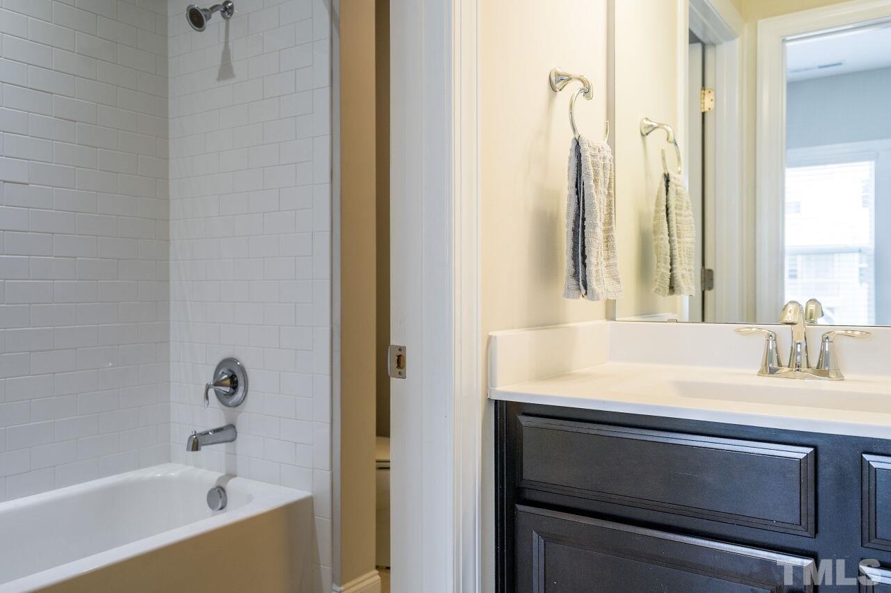 5264 Aleppo Lane Raleigh, NC 27613 - Photo 24 of 30 Subway tile adorns this upstairs full bath shower.