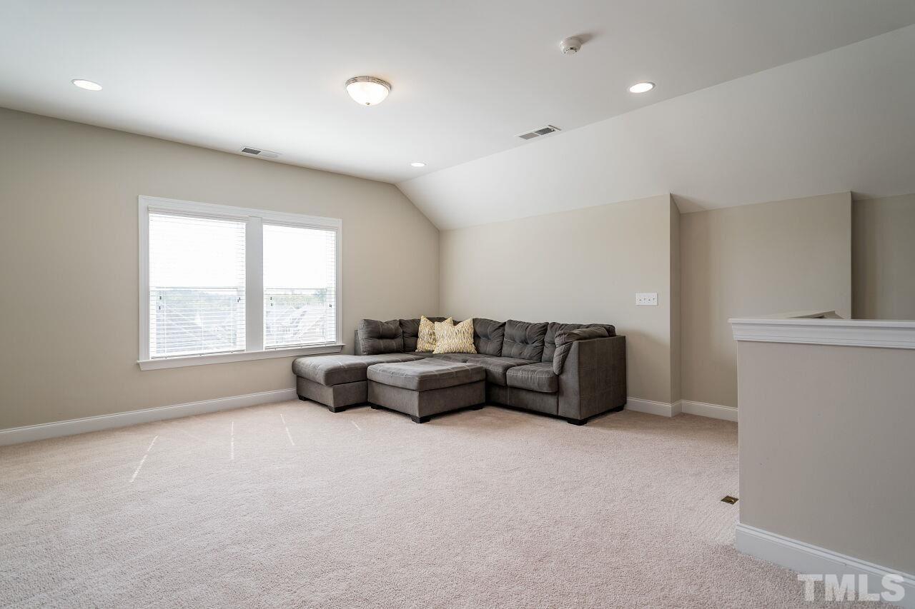 5264 Aleppo Lane Raleigh, NC 27613 - Photo 26 of 30 Third floor bonus space with full bath perfect for movie night, hangout, or another home office. Unfinished walk in attic space nearby for storage or future expansion.