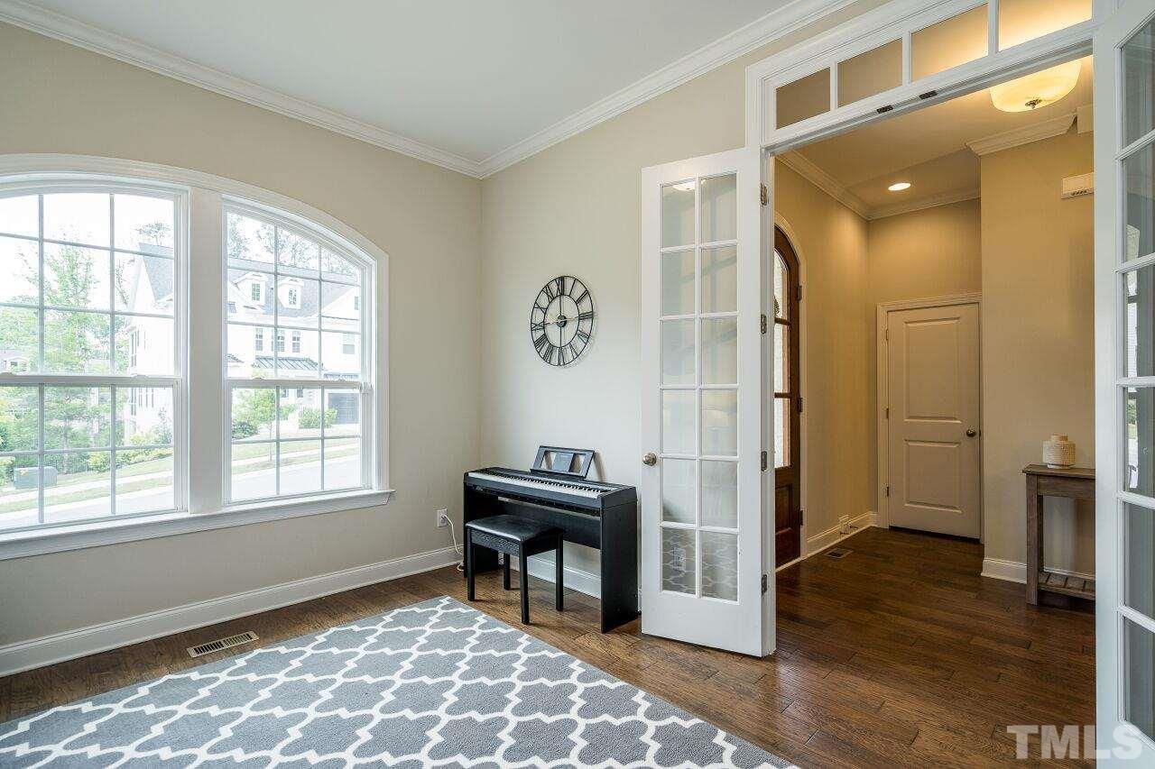 5264 Aleppo Lane Raleigh, NC 27613 - Photo 4 of 30 Front facing office has french glass doors and can quietly tuck away those working at the front of the house.