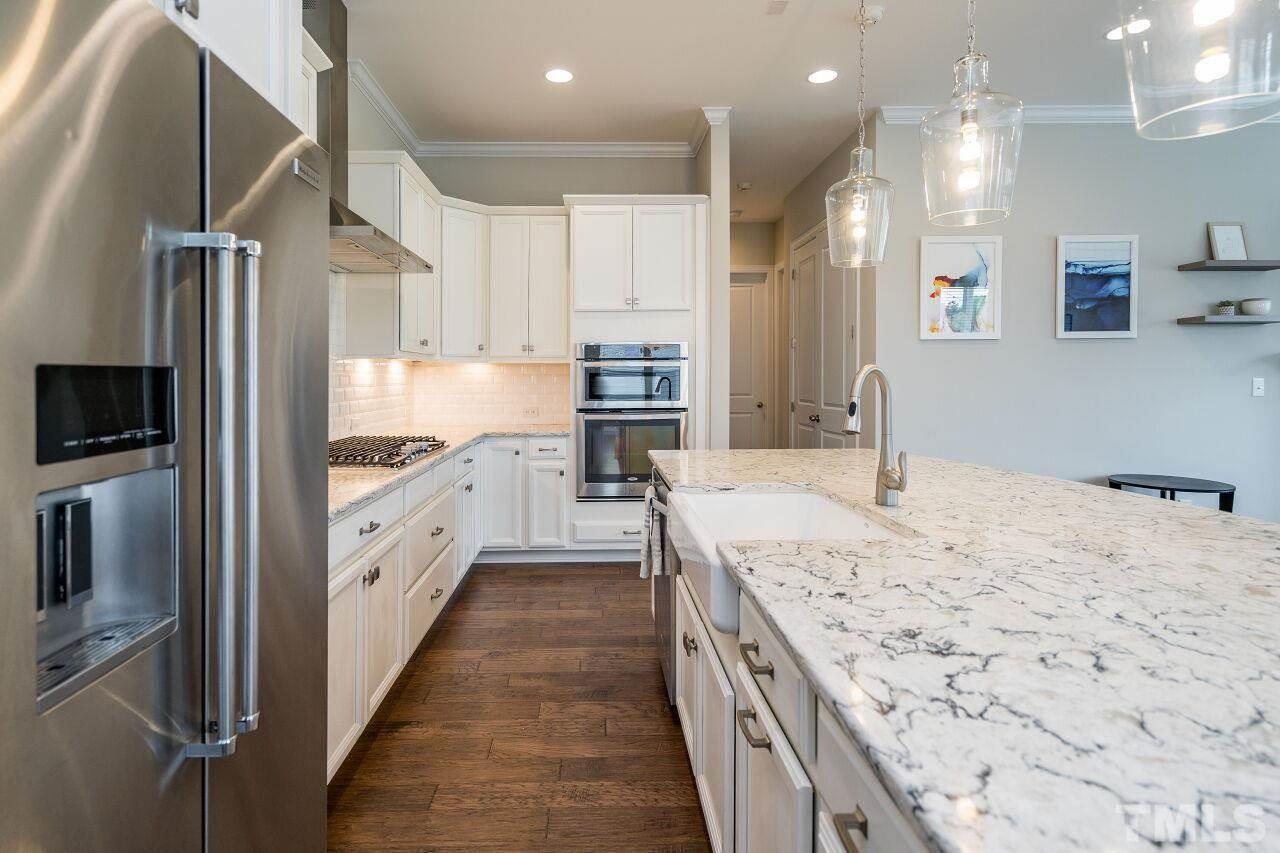 5264 Aleppo Lane Raleigh, NC 27613 - Photo 9 of 30 Farmhouse sink completes the look with quartz counters throughout the kitchen.