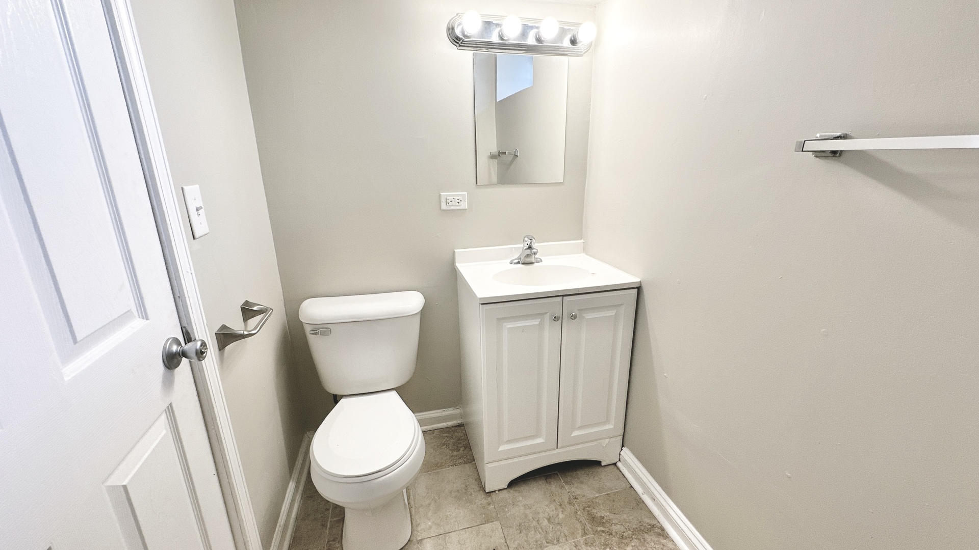 17303 Roy Street Lansing, IL 60438 - Photo 17 of 23 a bathroom with a toilet sink and mirror
