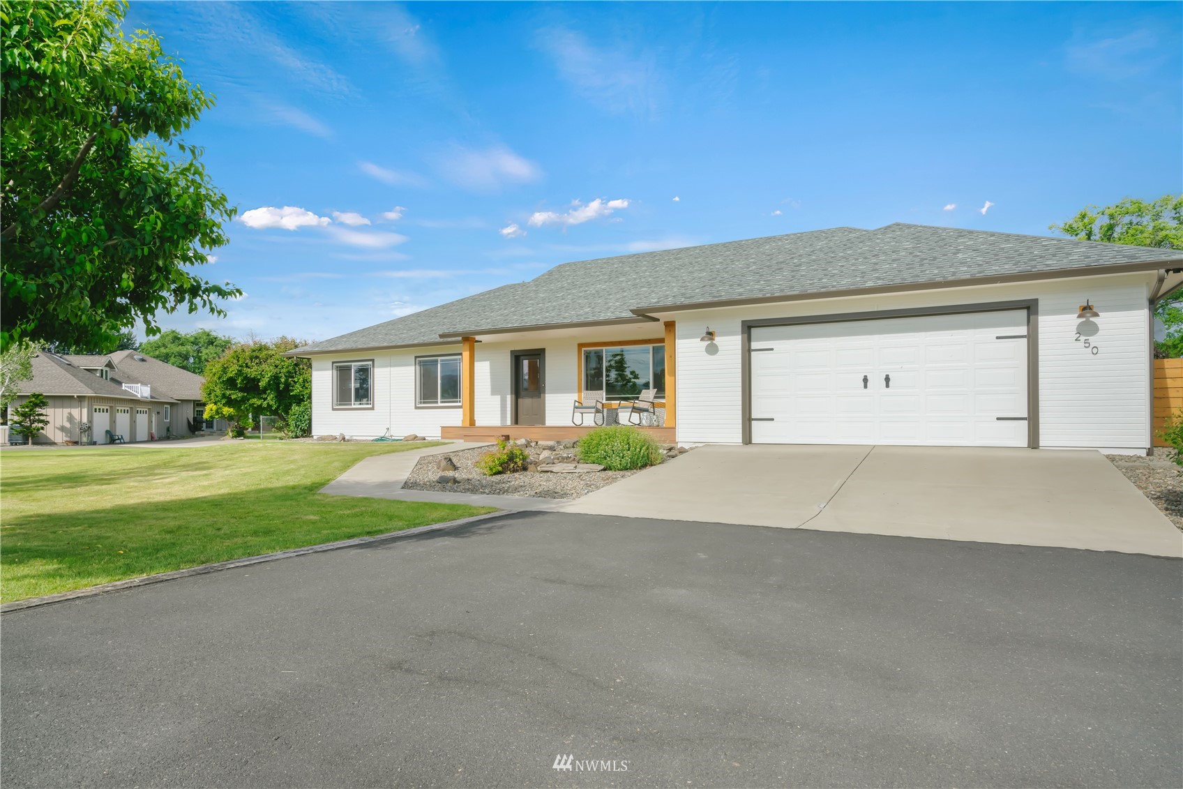 250 Rivers Edge Lane Yakima, WA 98901 - Photo 2 of 40 a front view of a house with a yard and garage