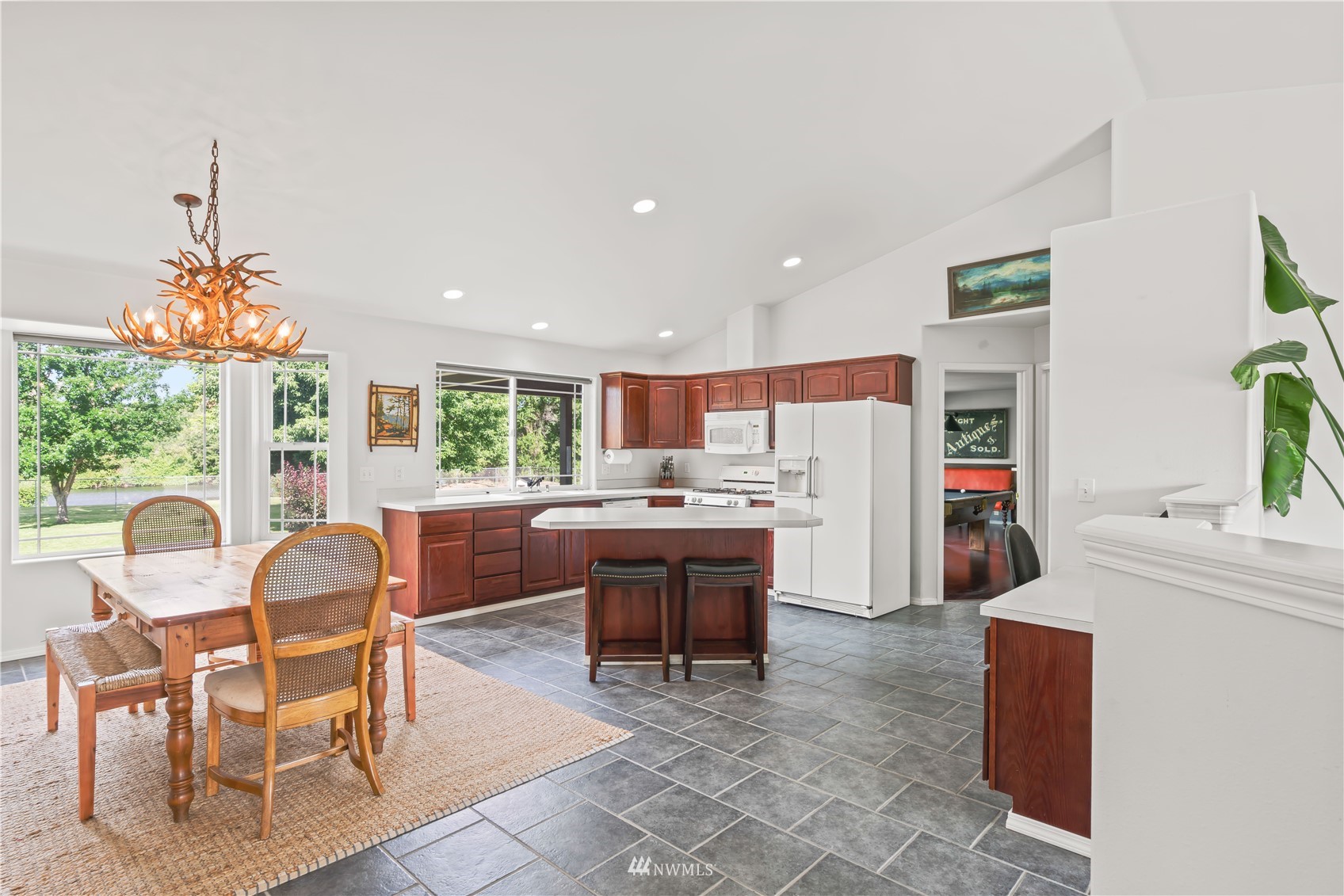 250 Rivers Edge Lane Yakima, WA 98901 - Photo 6 of 40 a kitchen with stainless steel appliances granite countertop a table chairs and a refrigerator