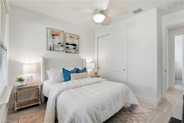 a bedroom with a large bed and a chandelier