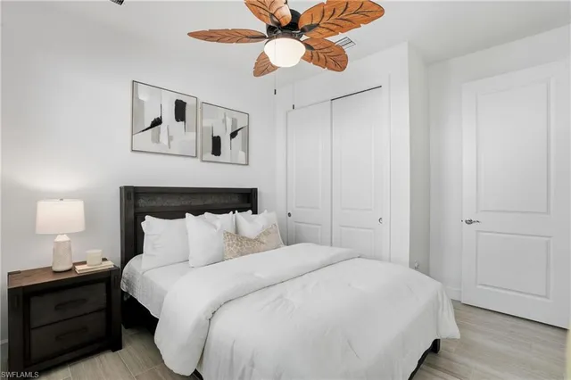 a bedroom with a bed mirror and window