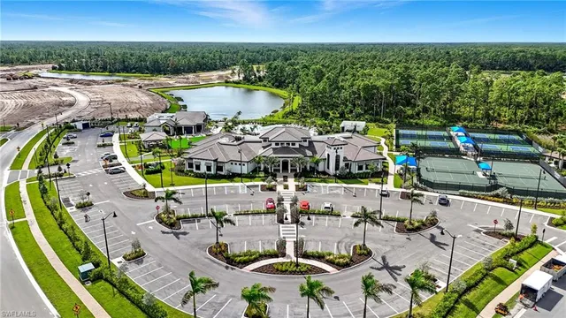 an aerial view of a swimming pool with outdoor seating and yard