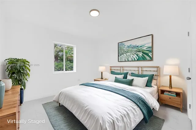 a bedroom with a bed and a potted plant