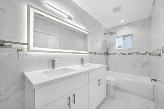 a bathroom with a sink a toilet and a bathtub