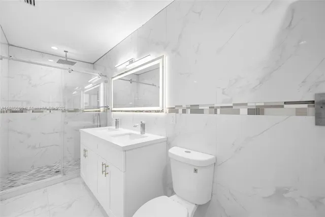 a view of a kitchen with refrigerator and a sink