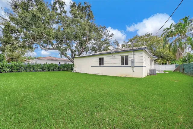 a view of backyard with swimming pool and outdoor seating