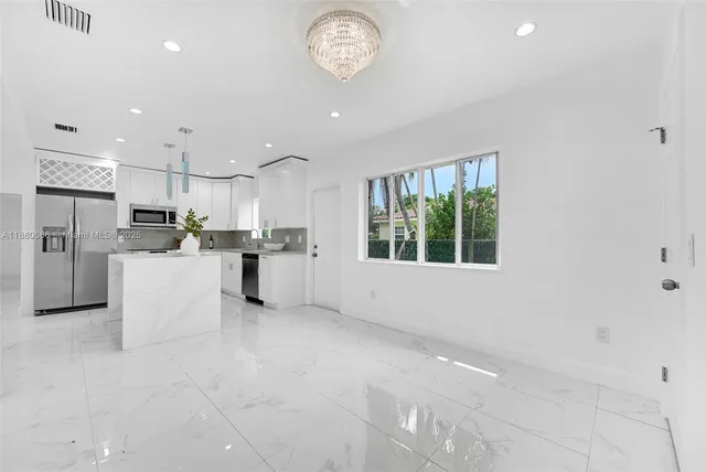 a view of kitchen with furniture and stainless steel appliances