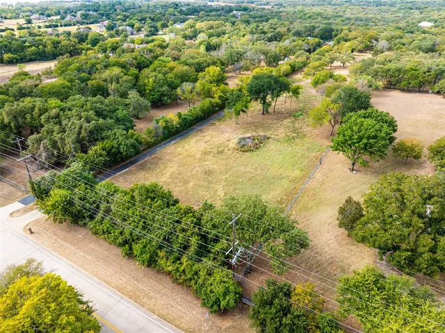 a view of a field with trees