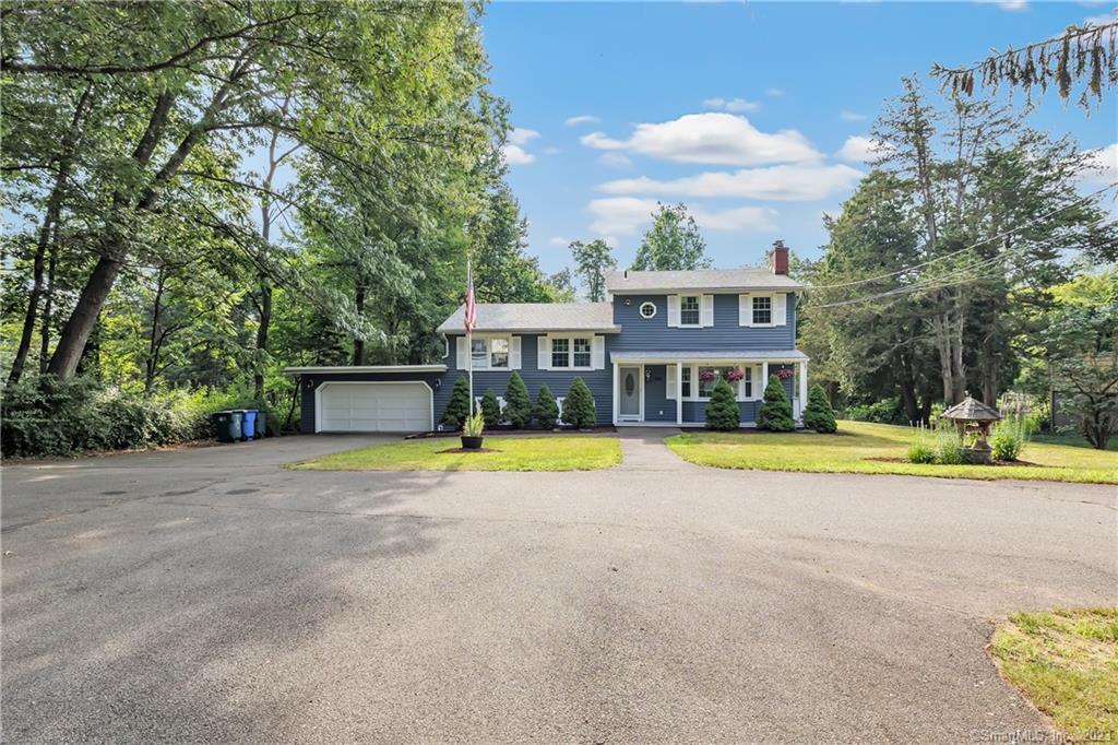 a view of an house with swimming pool and a yard