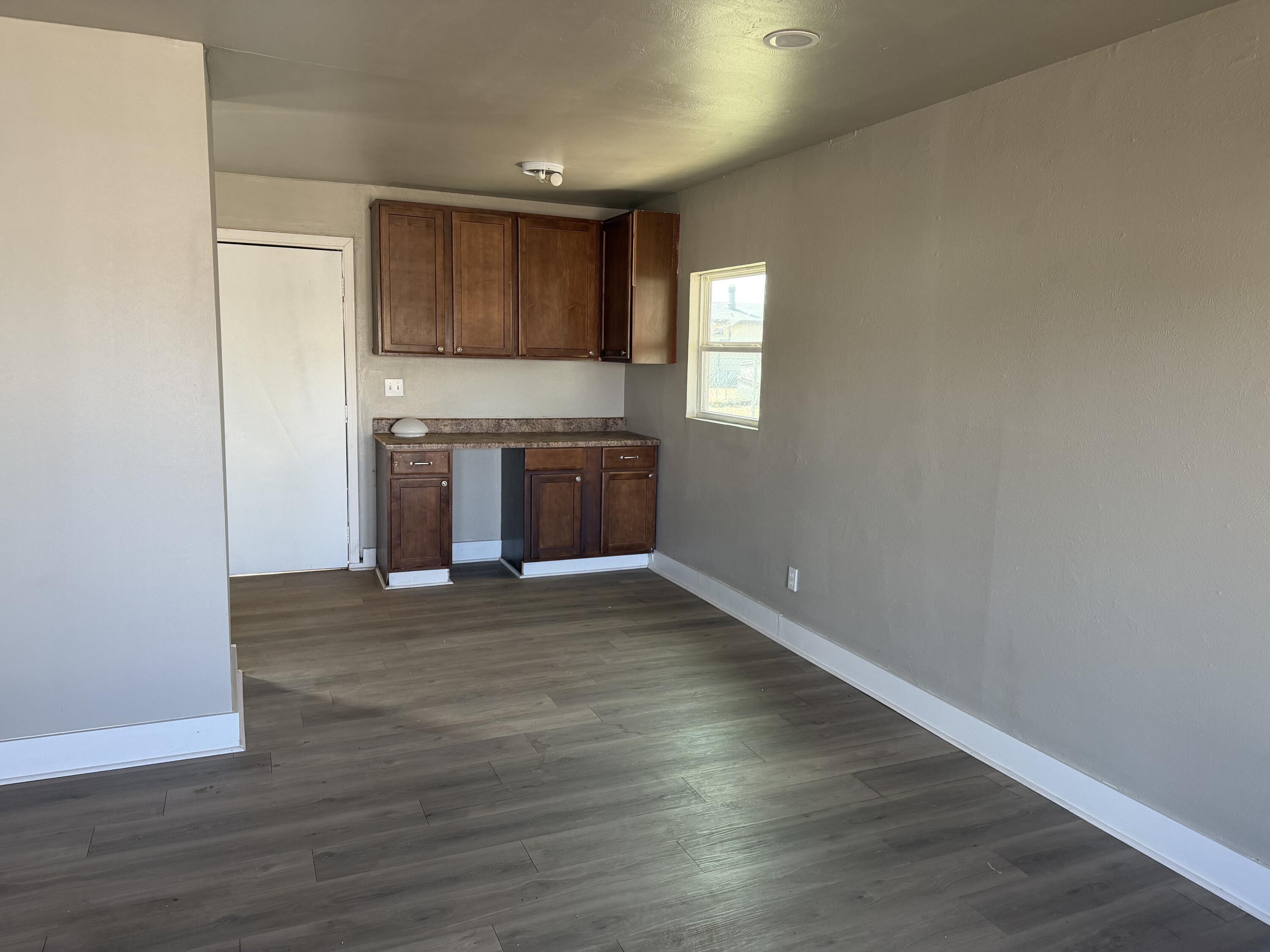 2906 Beech Avenue Lubbock, TX 79404 - Photo 4 of 10 a view of an empty room with a kitchen and a window