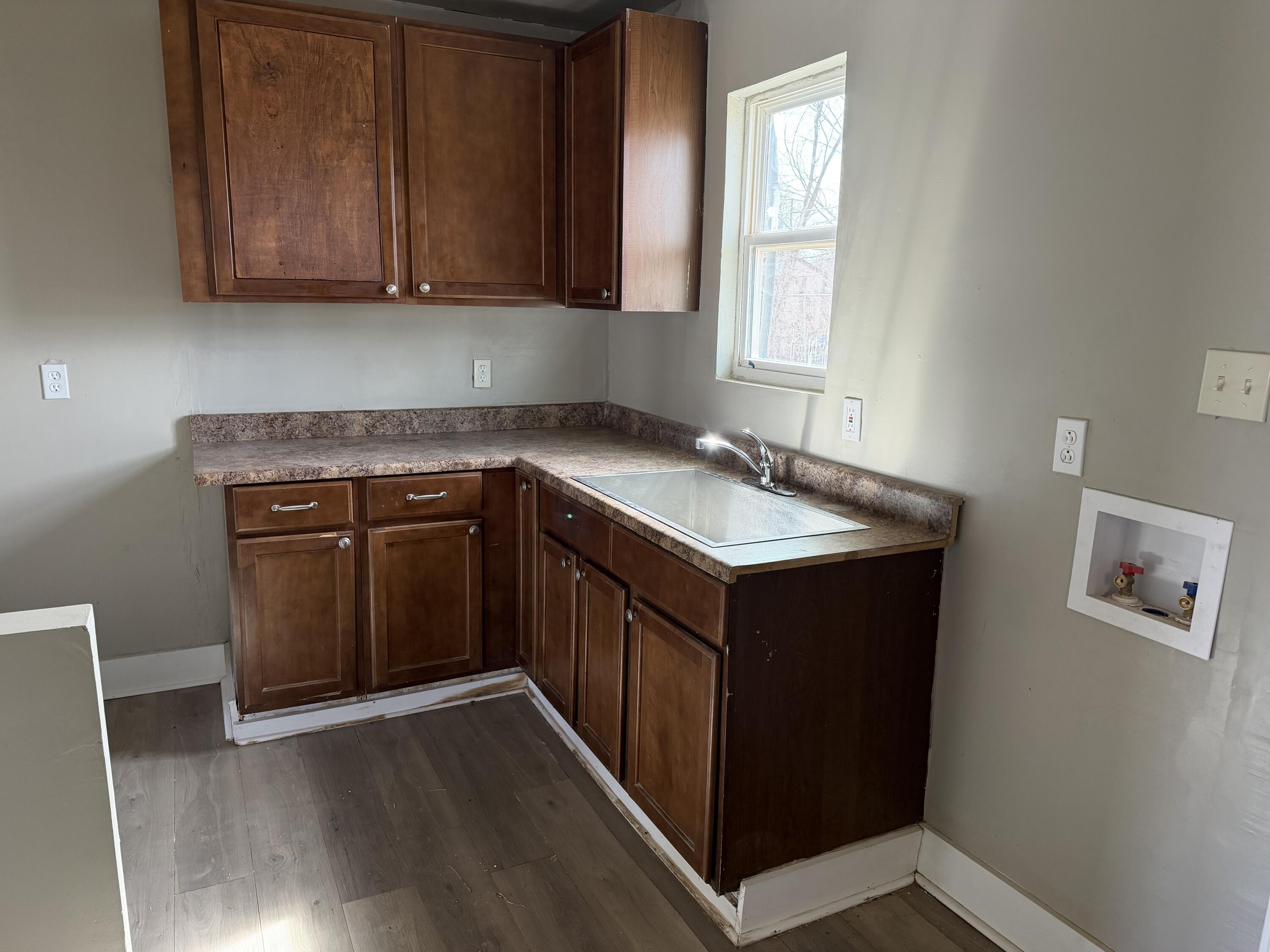 2906 Beech Avenue Lubbock, TX 79404 - Photo 5 of 10 a kitchen with a sink stove and cabinets
