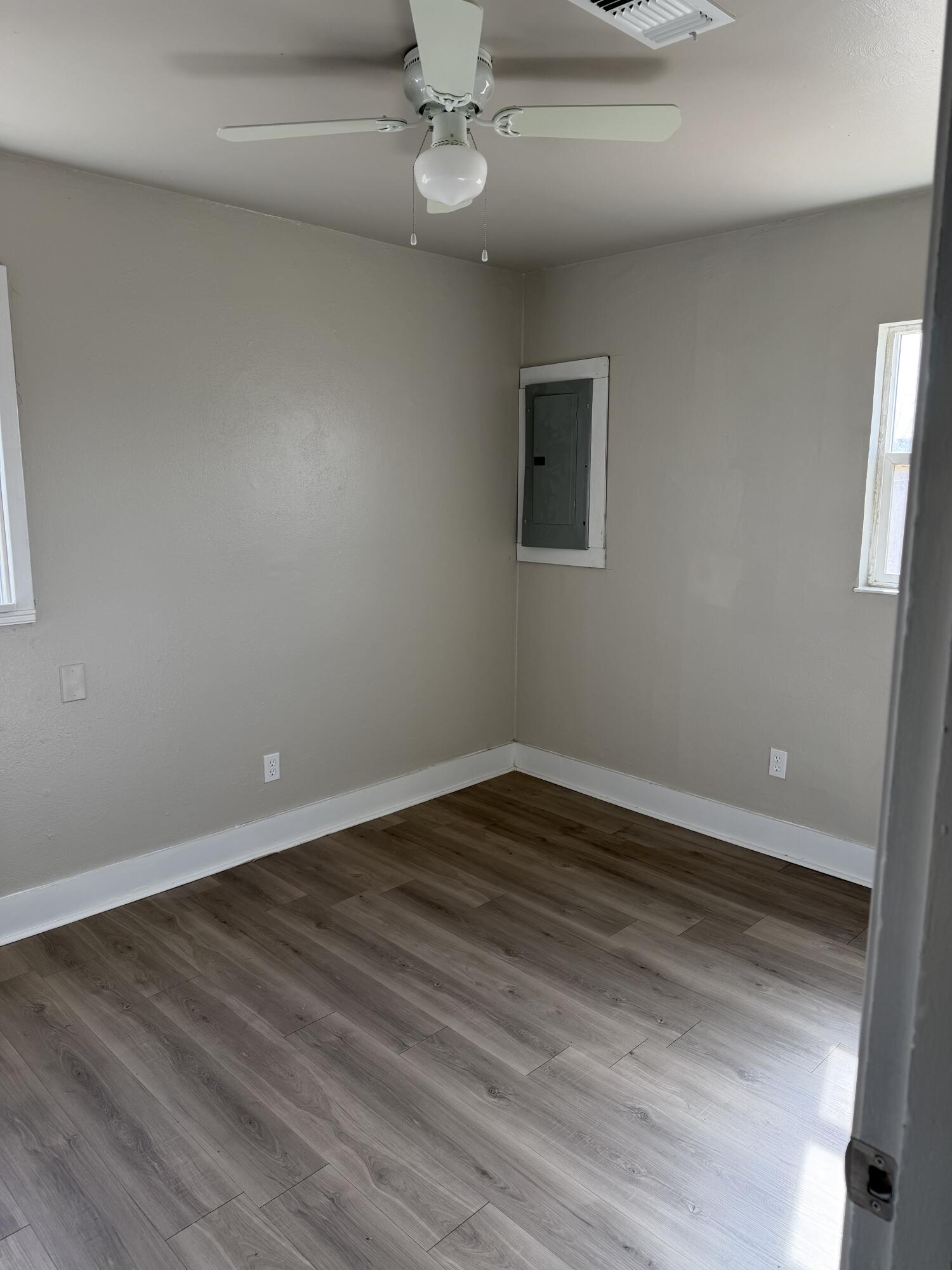 2906 Beech Avenue Lubbock, TX 79404 - Photo 7 of 10 a view of an empty room with wooden floor and a window