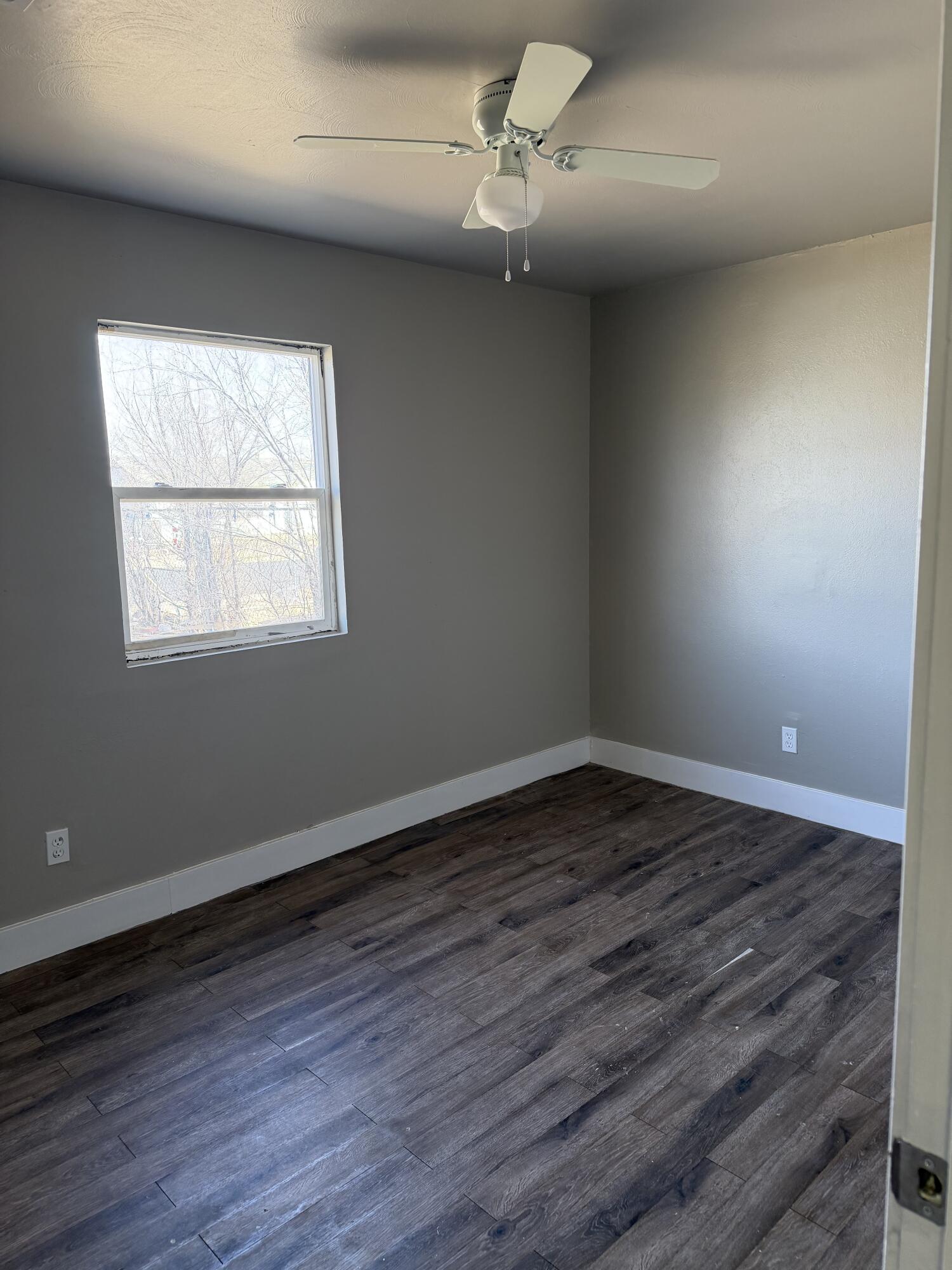 2906 Beech Avenue Lubbock, TX 79404 - Photo 9 of 10 wooden floor in an empty room with a window