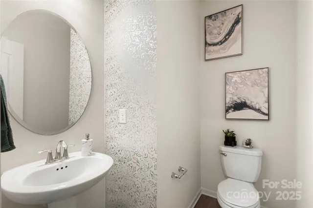 a bathroom with a toilet a sink and mirror