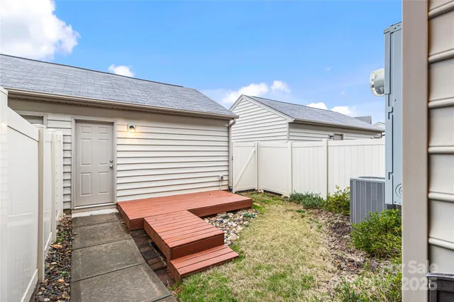 a backyard of a house with a table and chairs