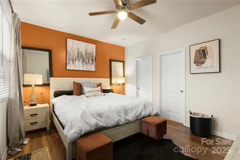 a bedroom with a bed and wooden floor