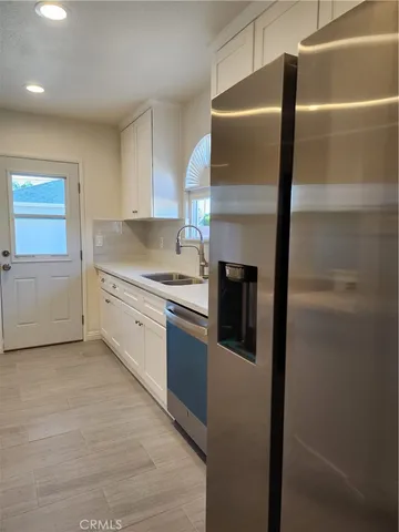 a kitchen with a refrigerator and a stove