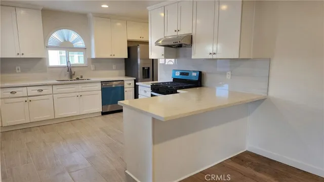 a kitchen with a sink cabinets and window