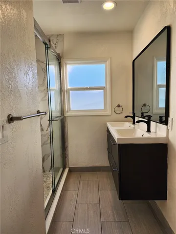 a bathroom with a shower and a sink