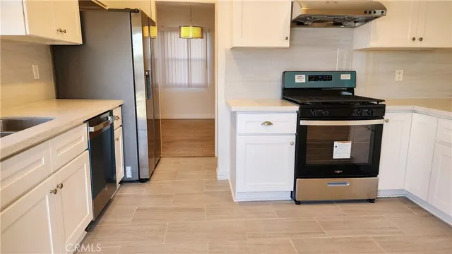 a kitchen with stainless steel appliances a stove and a refrigerator