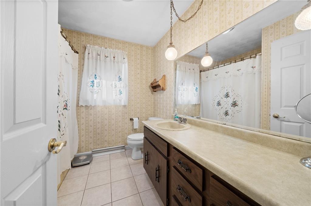338 Hellein School Road Donegal, PA 15628 - Photo 31 of 46 a spacious bathroom with a granite countertop sink a toilet and shower