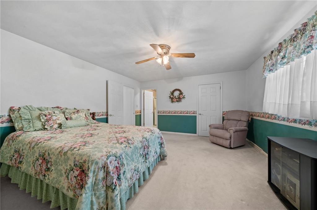 338 Hellein School Road Donegal, PA 15628 - Photo 36 of 46 a bedroom with a bed and a chandelier