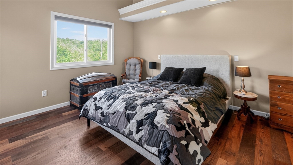 5 Governors Way, Unit B Milford, MA 01757 - Photo 32 of 42 a bed sitting in a bedroom next to a window