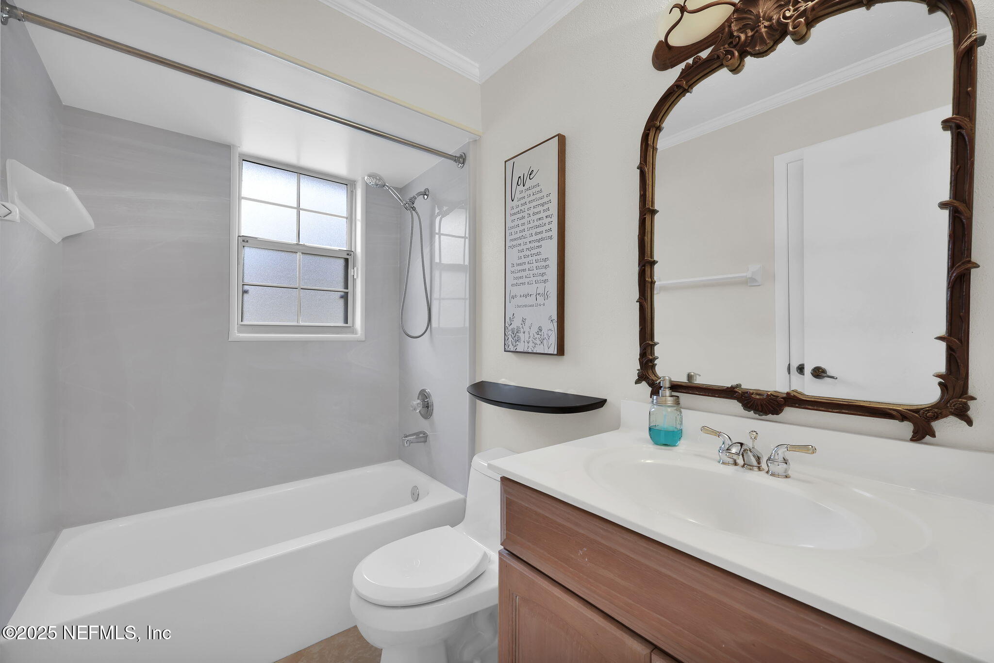 4607 Seaboard Avenue Jacksonville, FL 32210 - Photo 13 of 18 a bathroom with a granite countertop sink a toilet a mirror and bathtub