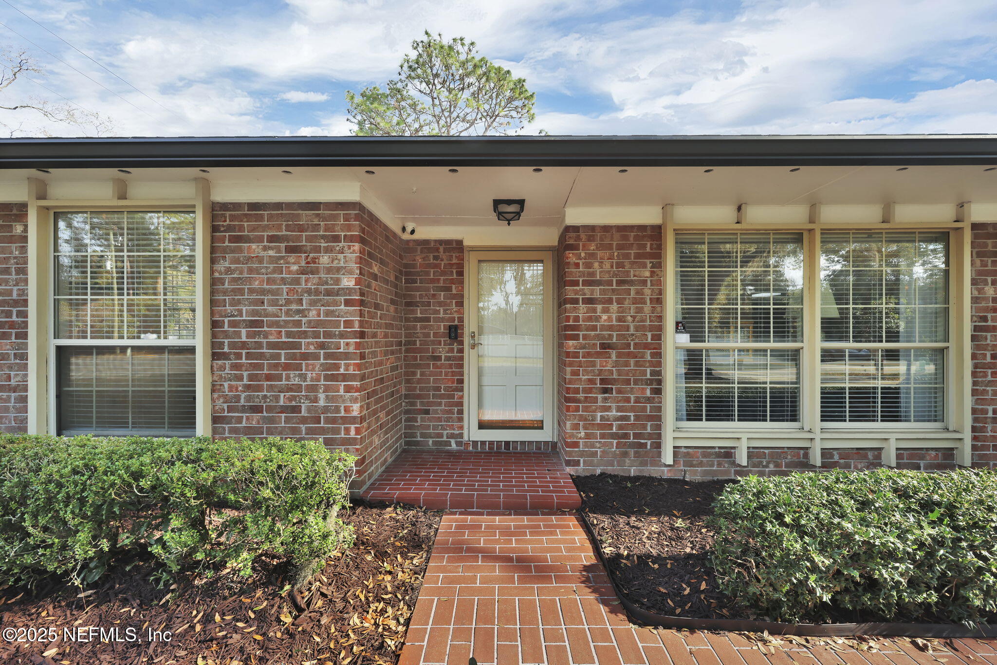 4607 Seaboard Avenue Jacksonville, FL 32210 - Photo 2 of 18 a front view of a building with a garden