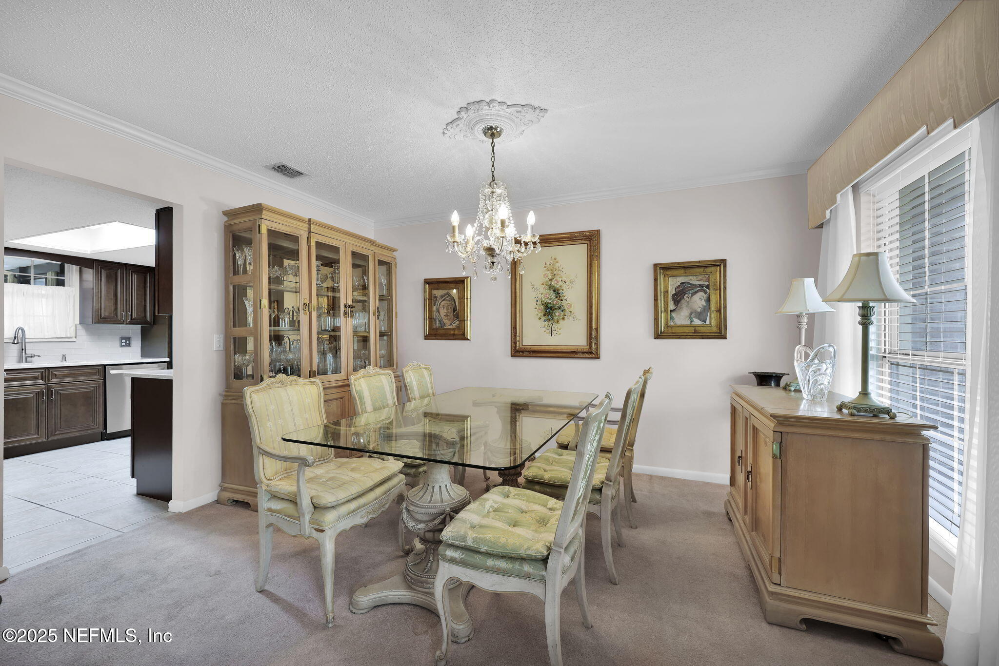 4607 Seaboard Avenue Jacksonville, FL 32210 - Photo 5 of 18 a view of a dining room with furniture and chandelier