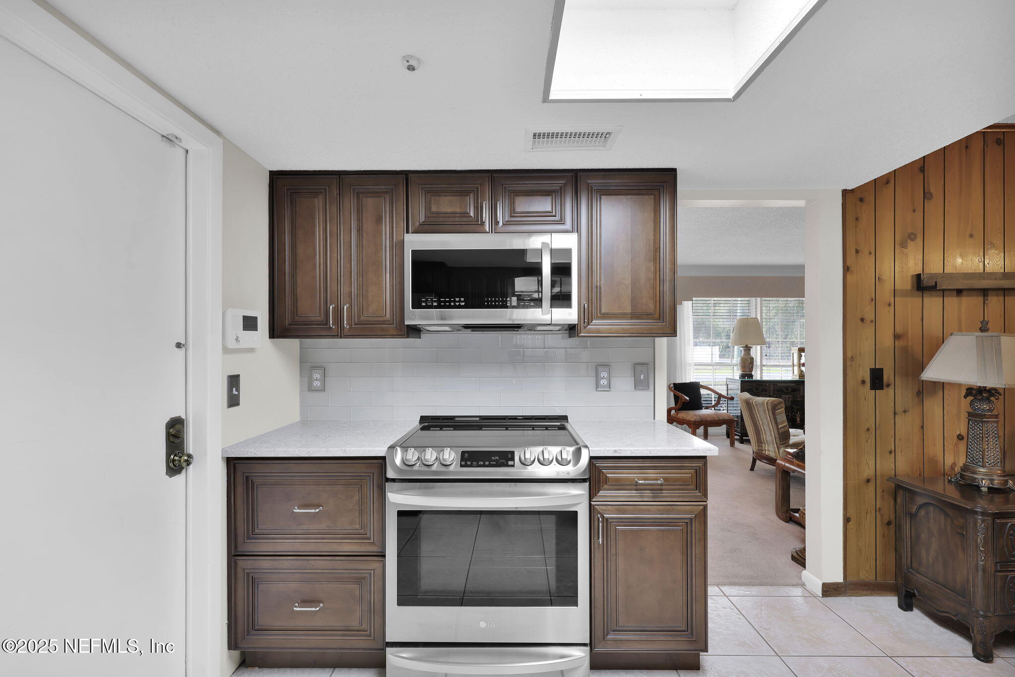 4607 Seaboard Avenue Jacksonville, FL 32210 - Photo 7 of 18 a kitchen with a stove and a microwave