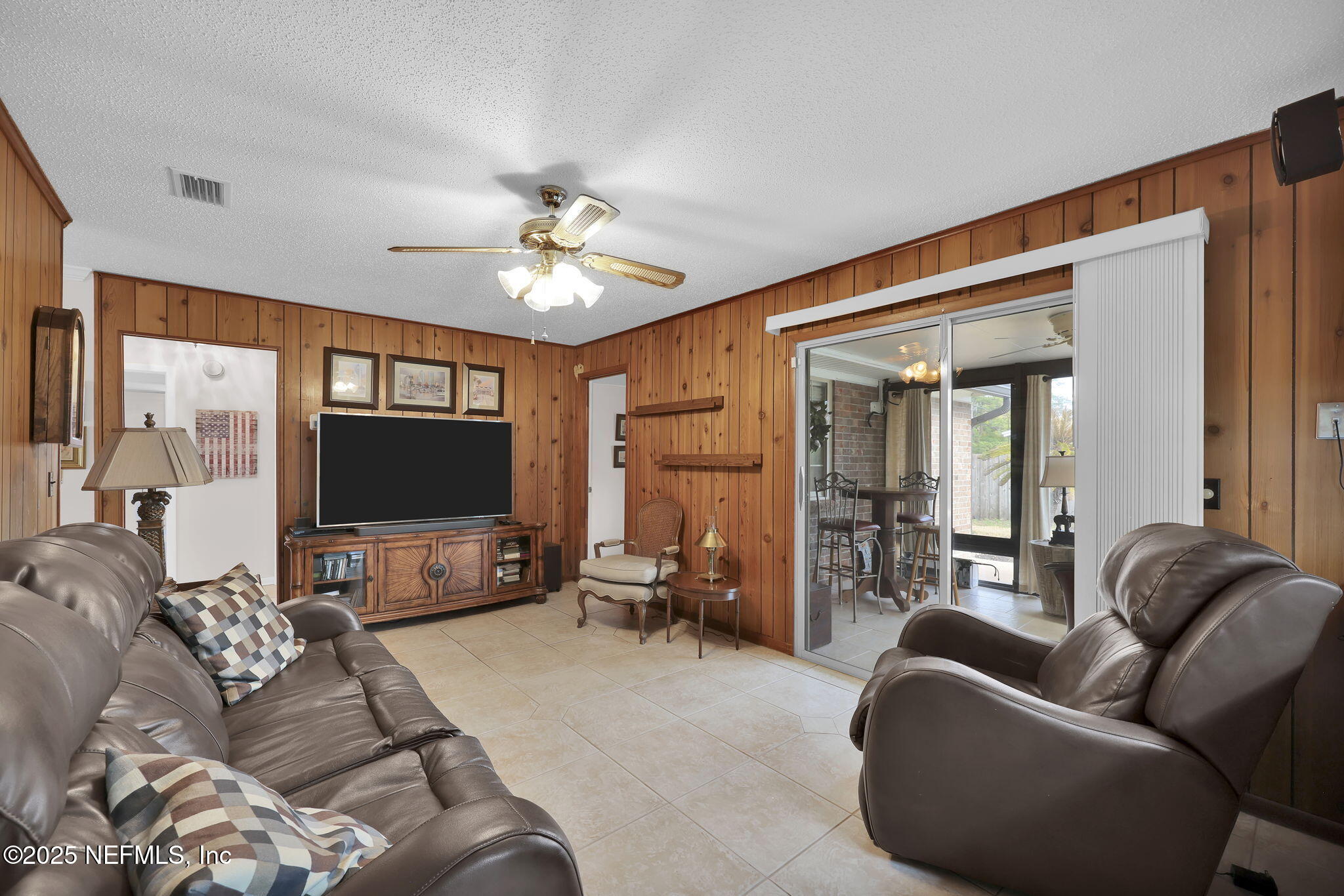 4607 Seaboard Avenue Jacksonville, FL 32210 - Photo 9 of 18 a living room with furniture and a flat screen tv