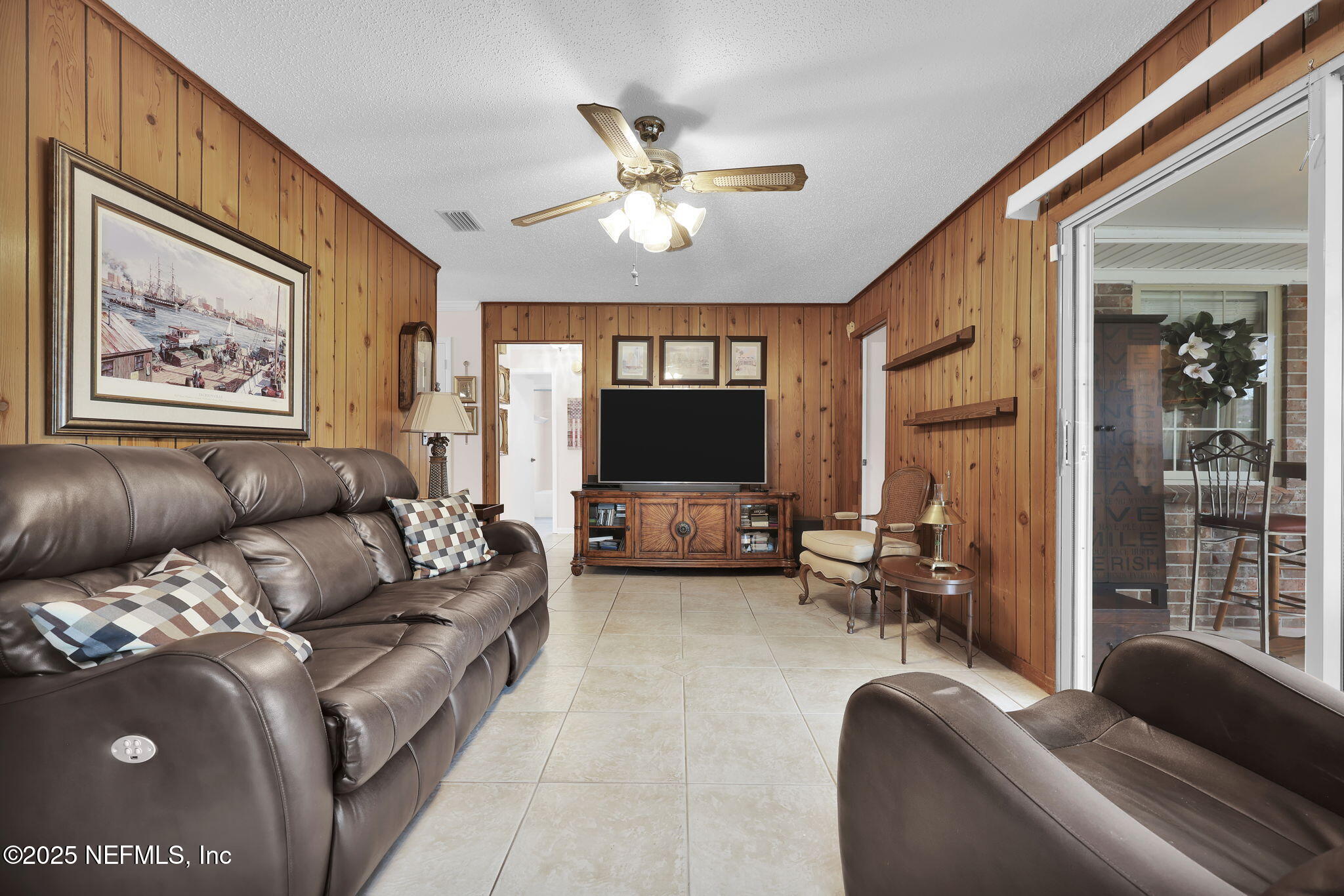 4607 Seaboard Avenue Jacksonville, FL 32210 - Photo 10 of 18 a living room with furniture and a flat screen tv