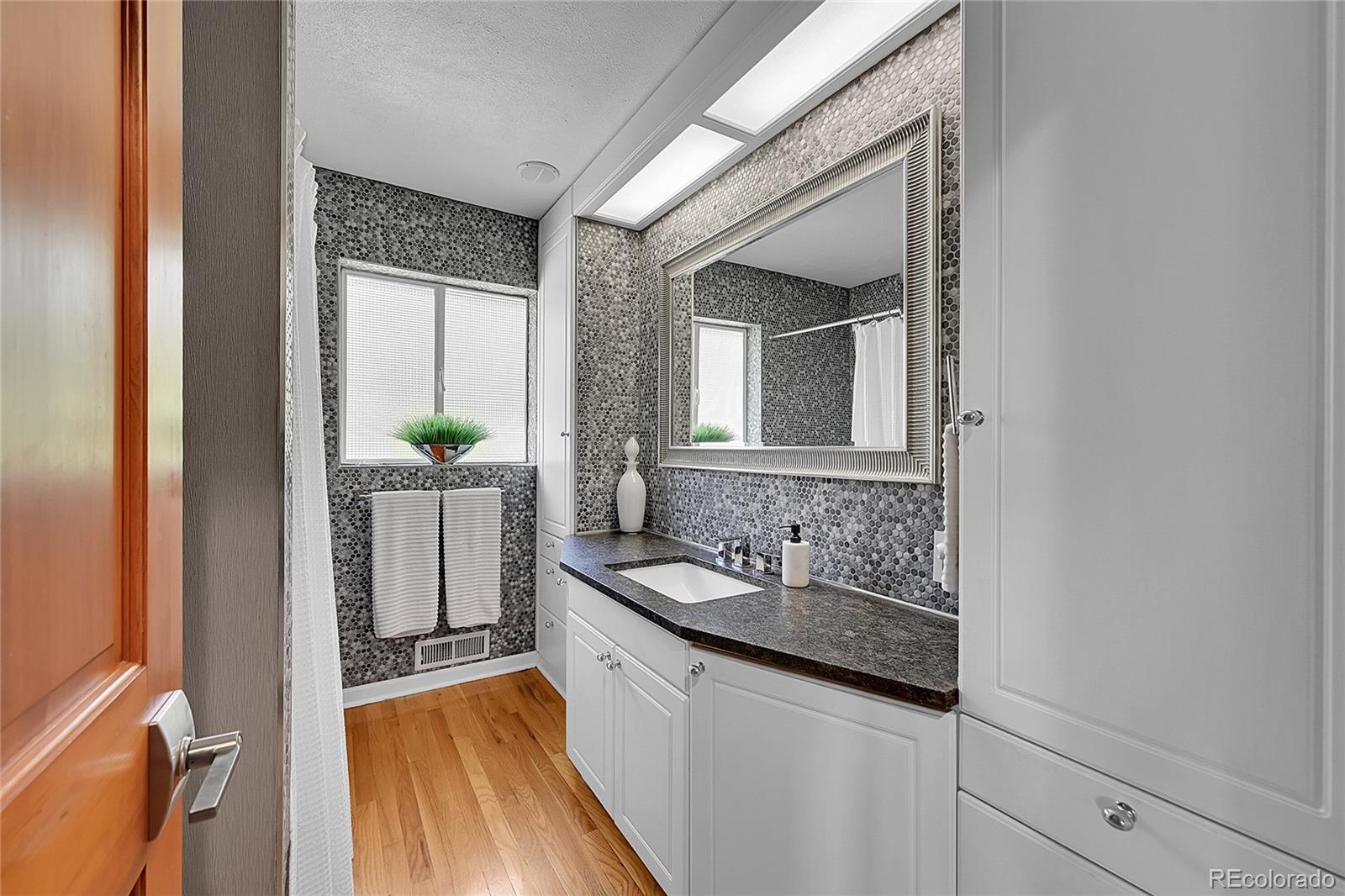 1500 West Ridge Road Littleton, CO 80120 - Photo 14 of 49 a bathroom with a sink and a mirror