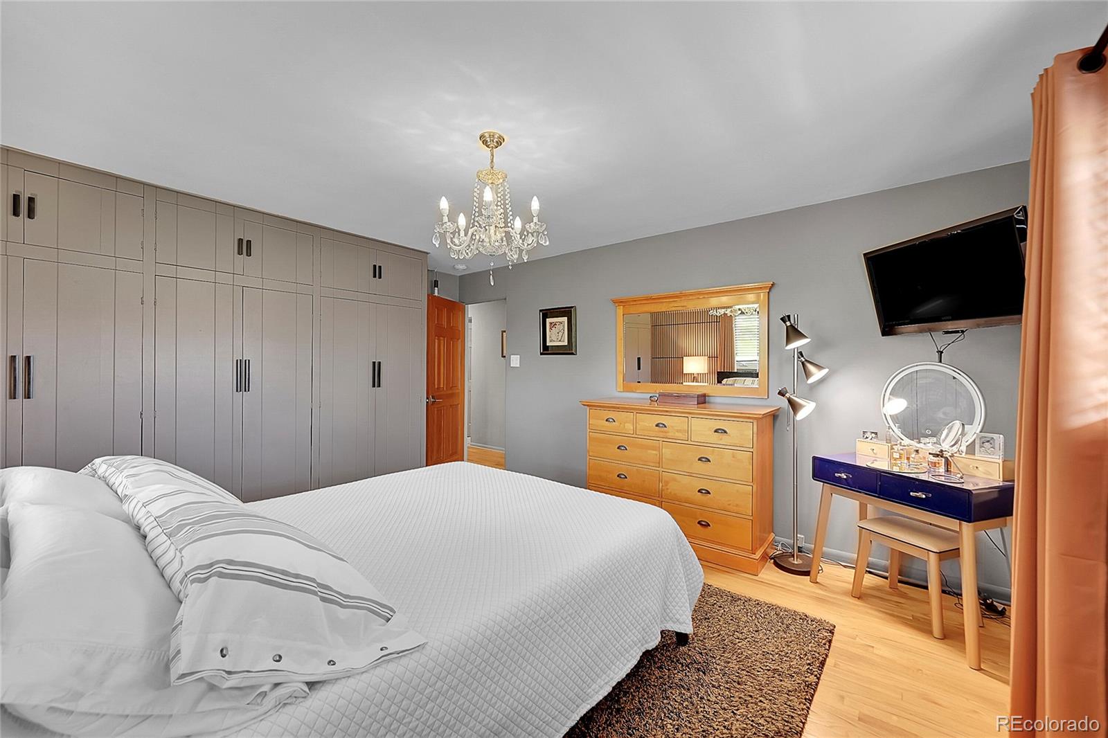 1500 West Ridge Road Littleton, CO 80120 - Photo 19 of 49 a bedroom with a bed and a flat screen tv