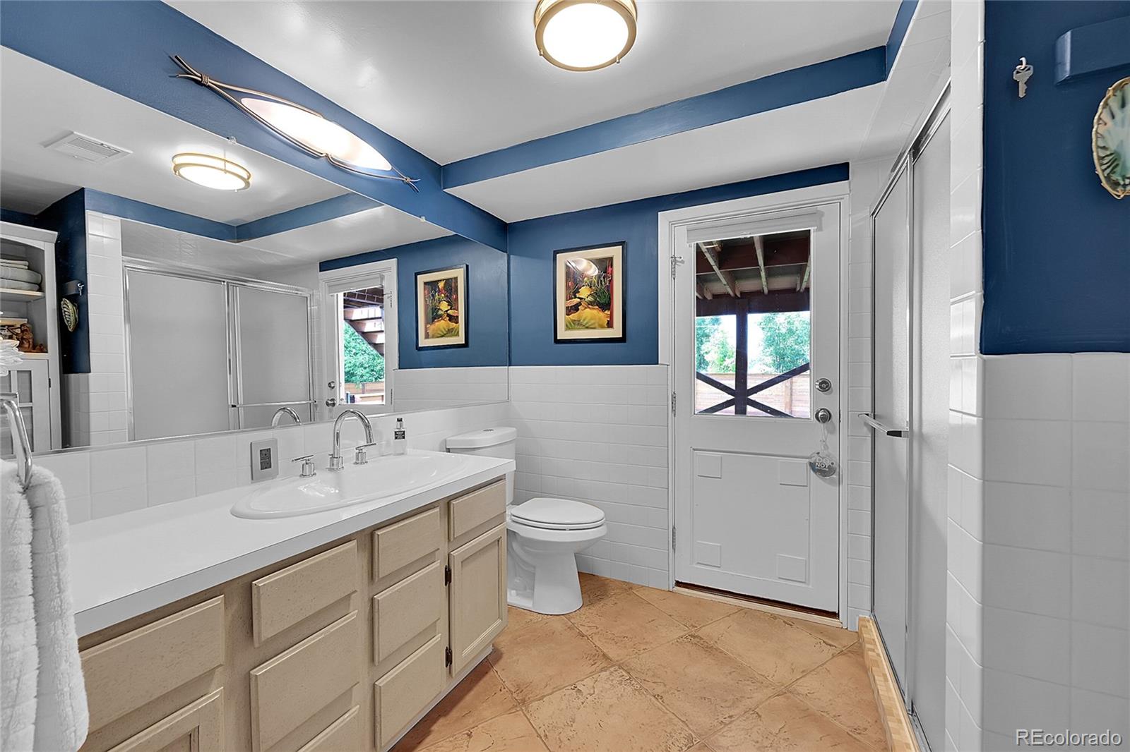 1500 West Ridge Road Littleton, CO 80120 - Photo 25 of 49 a bathroom with a toilet sink and mirror