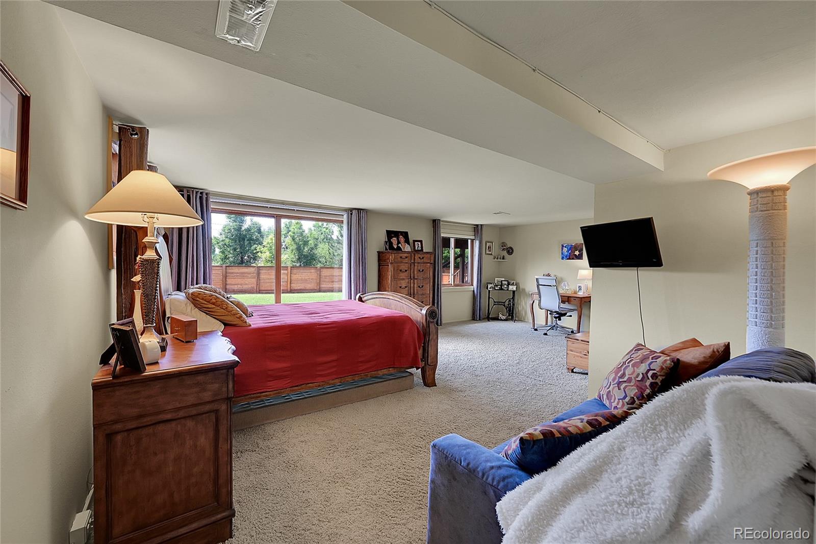 1500 West Ridge Road Littleton, CO 80120 - Photo 27 of 49 a bed room with furniture and a flat screen tv