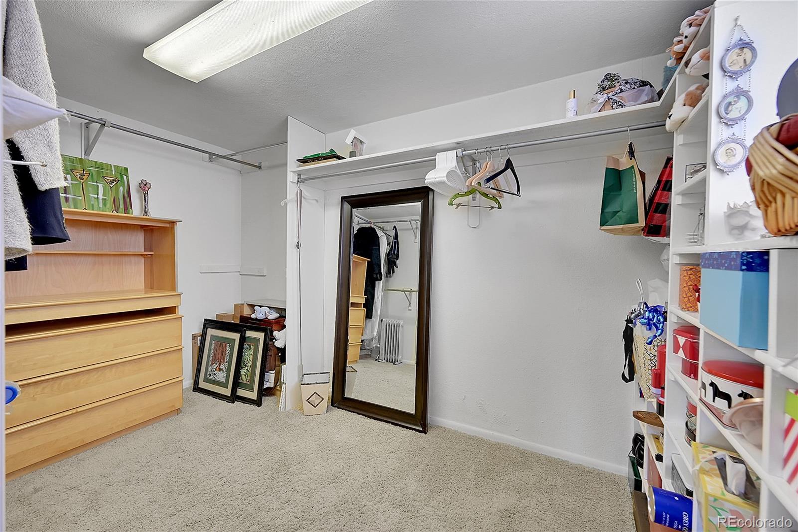 1500 West Ridge Road Littleton, CO 80120 - Photo 28 of 49 a view of walk in closet with clothes and shoes