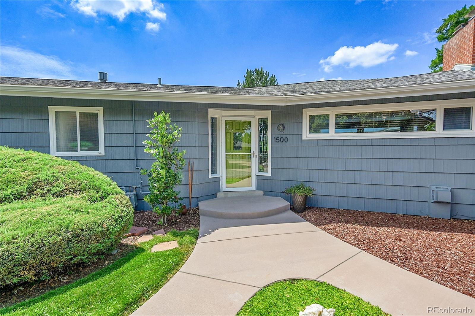 1500 West Ridge Road Littleton, CO 80120 - Photo 3 of 49 a view of a house with a small yard and plants