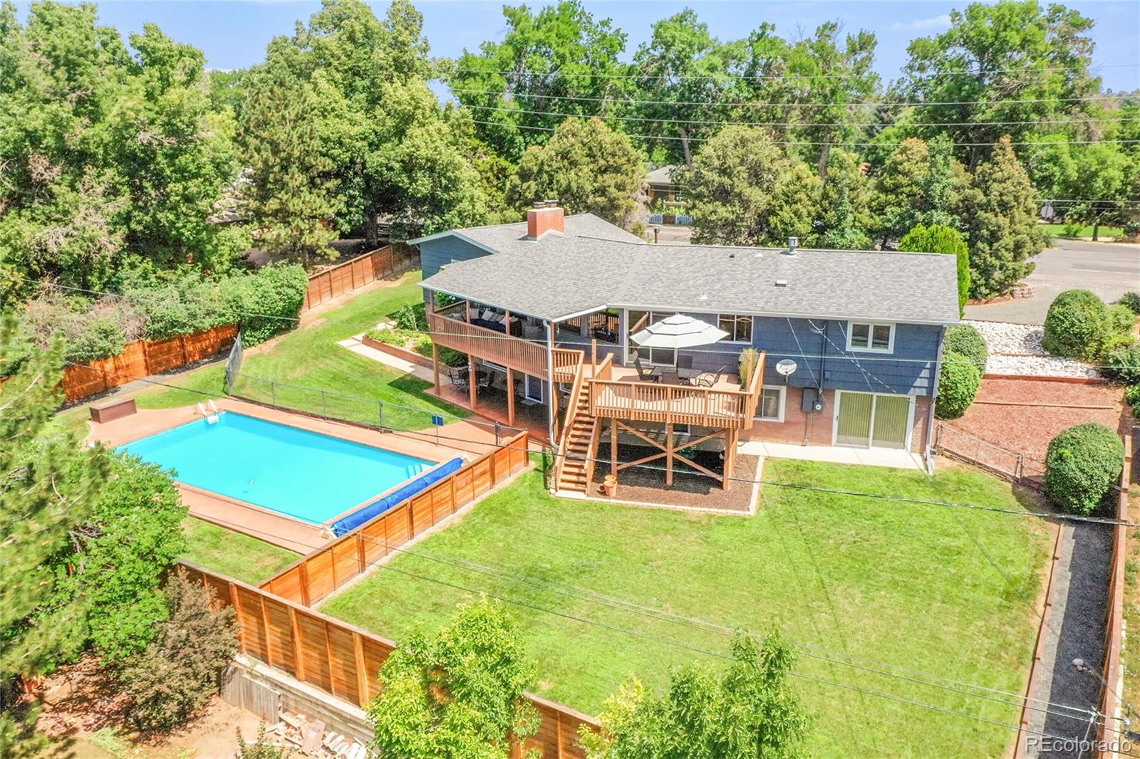 1500 West Ridge Road Littleton, CO 80120 - Photo 31 of 49 an aerial view of a house with swimming pool and large trees