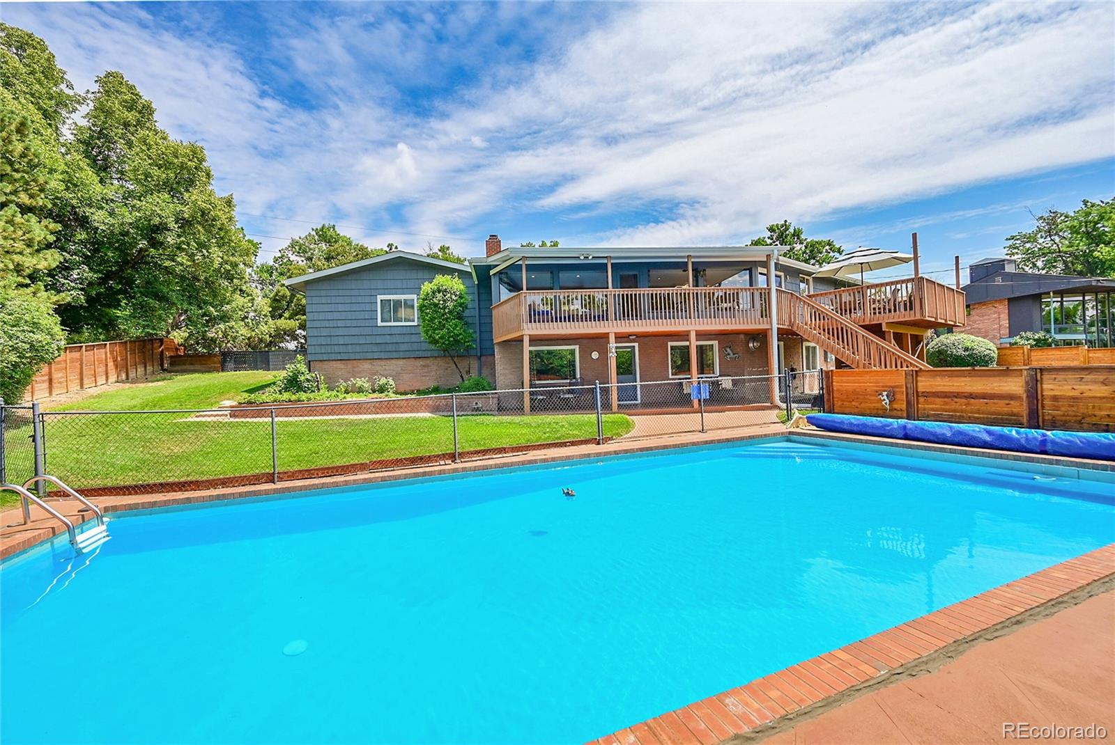 1500 West Ridge Road Littleton, CO 80120 - Photo 32 of 49 a view of pool with lawn chairs and large trees