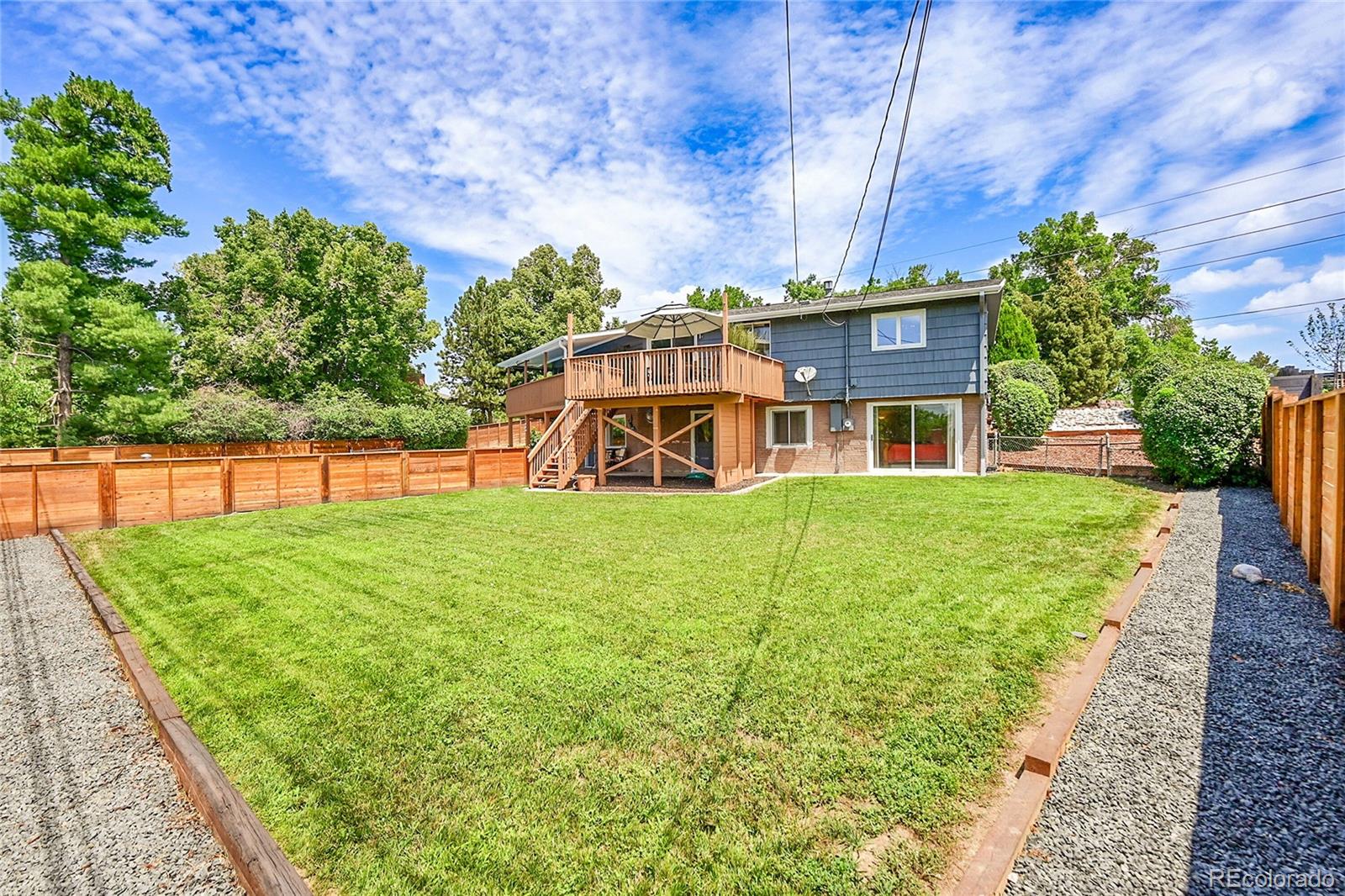 1500 West Ridge Road Littleton, CO 80120 - Photo 39 of 49 a view of a house with backyard and a tree