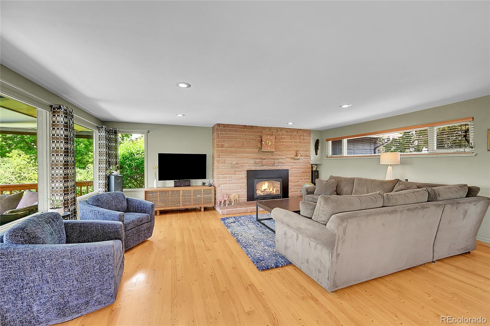 1500 West Ridge Road Littleton, CO 80120 - Photo 6 of 49 a living room with furniture and a fireplace