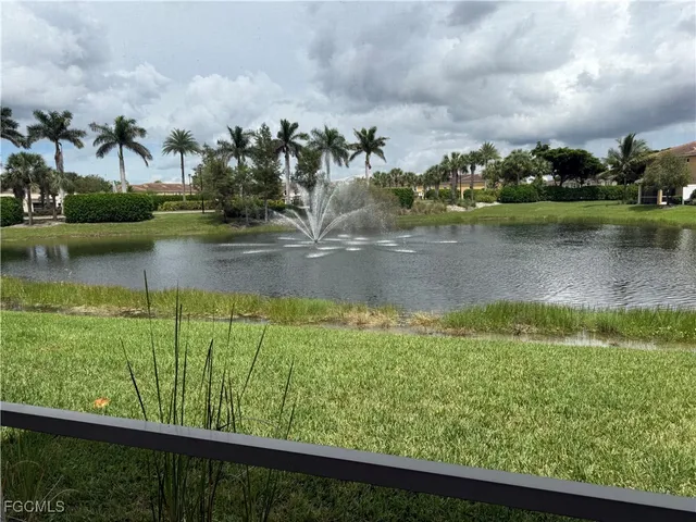 a view of a lake with houses in the back