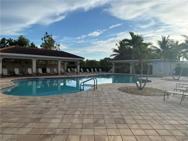 a view of a house with backyard and sitting area